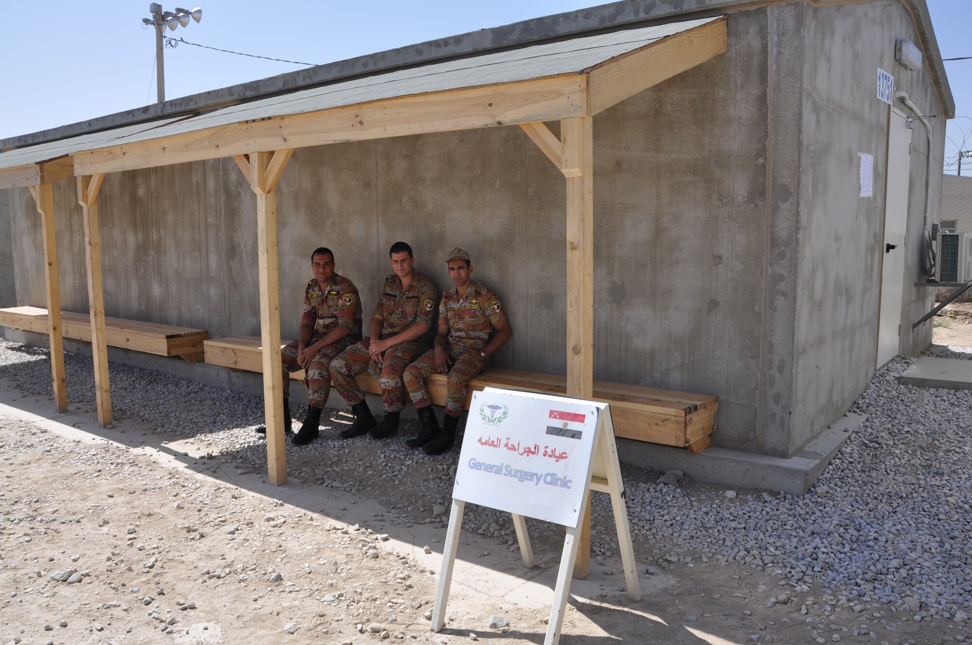 Service members from the Egyptian medical staff wait in front of the new general surgery clinic before the re-opening of the El Salam Egyptian field hospital on Bagram Airfield, Afghanistan, June 22. The field hospital had been closed as the unit there prepared for performing their changeover and equipment accountability processes (U.S. Air Force photo/Tech. Sgt. Rob Hazelett)