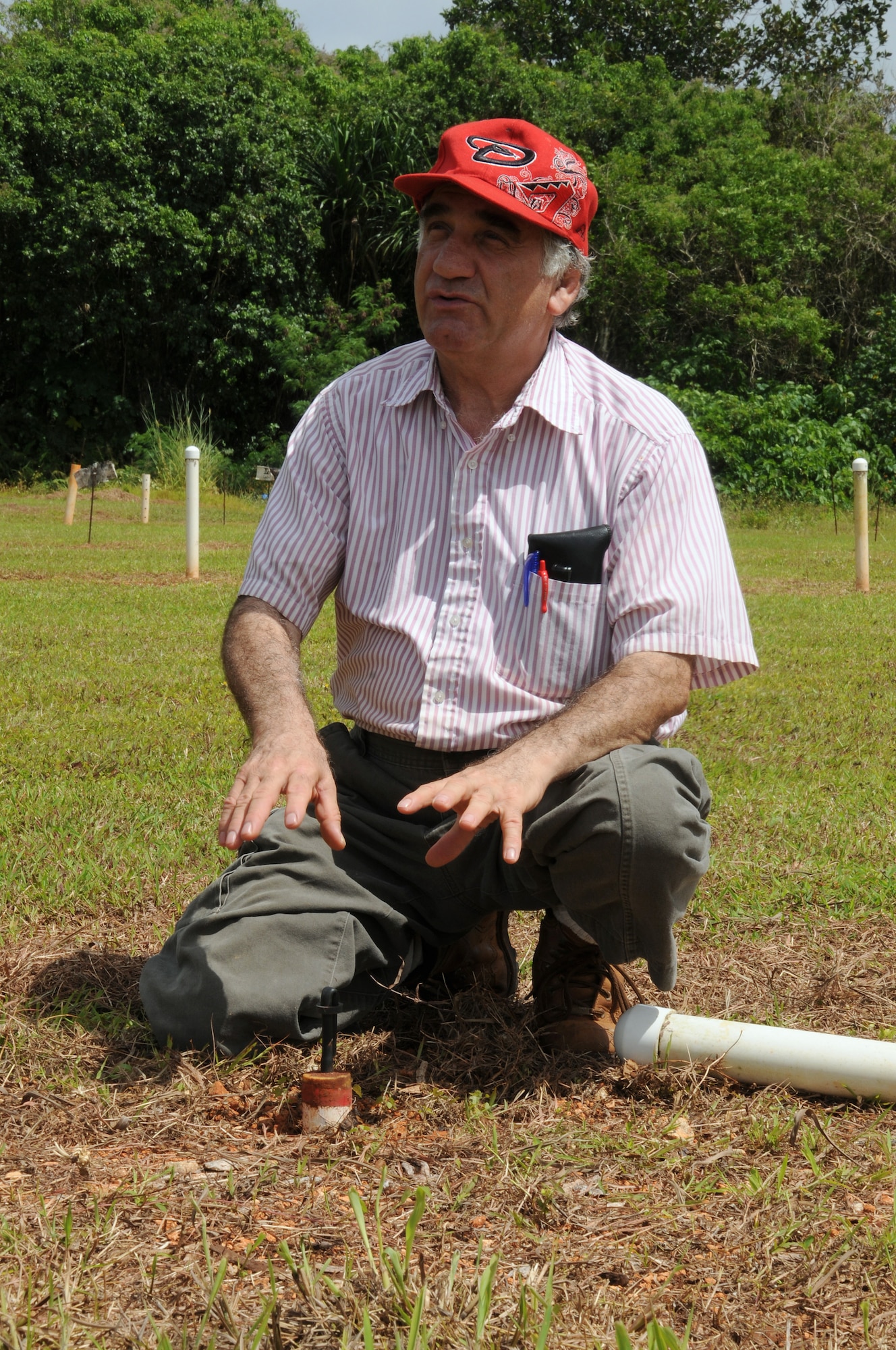 Mohammad Golabi, University of Guam associate professor of soil and environmental sciences, explains how lysimeters are used to measure the environmental impact on groundwater for a composting experiment June 19, 2013, at the UOG Research Farm in Yigo, Guam. The professor, technicians and students collected nearly 250 cubic yards of mulch from Andersen Air Force Base, Guam, throughout the year for a project that will benefit the local agriculture community. (U.S. Air Force photo by Staff Sgt. Melissa B. White/Released)