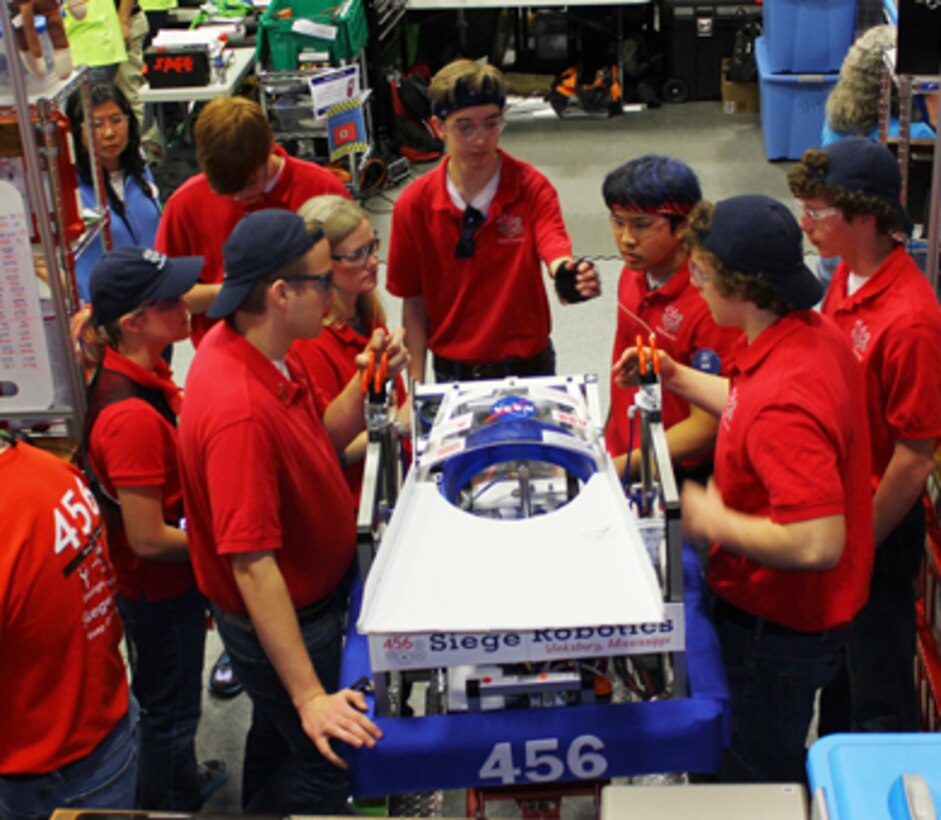 Vicksburg 456 Siege Robotics team members prepare the robot for competitions.