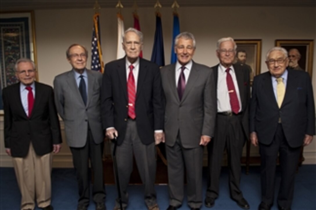 Secretary of Defense Chuck Hagel, third from right, and former Secretaries of Defense Frank Carlucci, left, William Perry, second from left, James Schlesinger, third from left, Harold Brown, second from right, and former Secretary of State Henry Kissinger pose for a group photograph after the meeting of the Defense Policy Board in the Pentagon in Arlington, Va. on June 18, 2013.  Hagel hosted the gathering to discuss the challenges faced by the Department of Defense and to get some prospective from his predecessors.  
