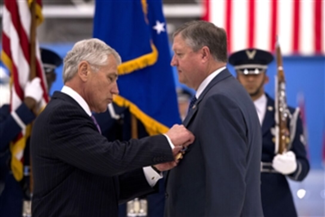 Secretary of Defense Chuck Hagel, left, presents Secretary of the Air Force Michael B. Donley with the Department of Defense Medal for Distinguished Public Service during his farewell ceremony at Joint Base Andrews, Md., June 21, 2013.  Donley served as the 22nd and longest serving secretary of the Air Force. 