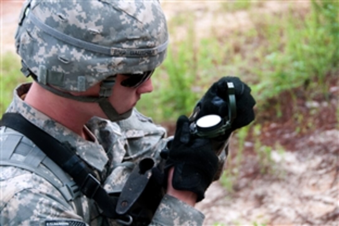 A paratrooper uses a compass to find his way to the next point during the land navigation part of expert infantryman badge testing on Fort Bragg, N.C., June 9, 2013. The paratrooper is assigned to the 82nd Airborne Division's 1st Brigade Combat Team. The testing is one of the seven major events that must be passed to earn the expert infantryman badge.  