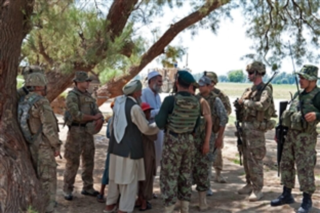 U.S. and Afghan soldiers talk with local villagers during a dismounted patrol on the outskirts of Takiya Khana village in Bati Kot district in Afghanistan’s Nangarhar province, June 15, 2013.