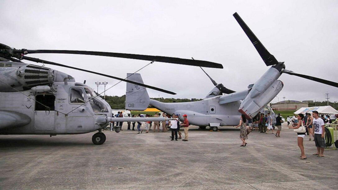 MARINE CORPS AIR STATION FUTENMA - A CH-53E Sea Stallion, left, and an MV-22B Osprey are displayed for Okinawa community members, status of forces agreement personnel and U.S. service members June 8 at Marine Corps Air Station Futenma during the 35th annual Futenma Flightline Fair. The Sea Stallion and Osprey are two of several aircraft and vehicles displayed at the fair. The aircraft at the fair are assigned to various units with the 1st Marine Aircraft Wing, III Marine Expeditionary Force, and the U.S. Air Force’s 18th Wing. 