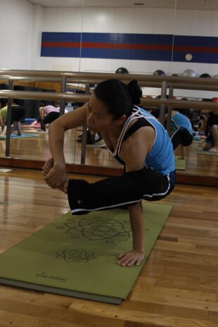 Prakai Parsons, IronWorks Gym yoga instructor, performs an asana during her Ashtanga, or power yoga class, held at IronWorks Gym at Marine Corps Air Station Iwakuni, Japan, June 13, 2013. Parsons said yoga became more than an exercise, but a healing process for her.