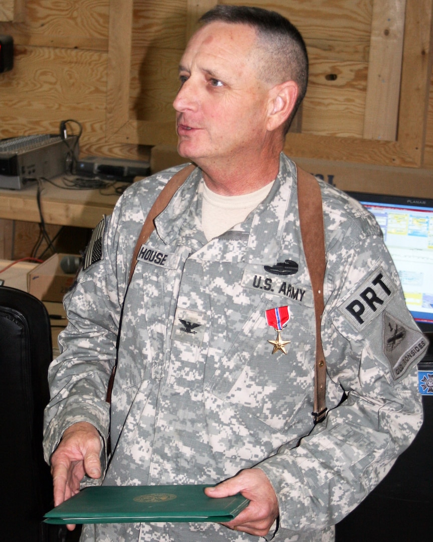 Army Col. Roy House, a rule of law advisor with the State Department's Baghdad Provincial Reconstruction Team, is presented the Bronze Star for his meritorious services while deployed in support of Operation Iraqi Freedom.