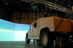 Much like an IMAX, a 280 degree screen brings to life real world scenarios designed to put a four-person fire team made up of a driver, gunner, rifleman and troop commander through the paces of an actual convoy mission.