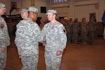 Maj. Gen. Joseph C. Carter, the adjutant general of the Massachusetts
National Guard, pins the Massachusetts Medal of Merit on Spc. Christopher
Brown II during a recent ceremony.