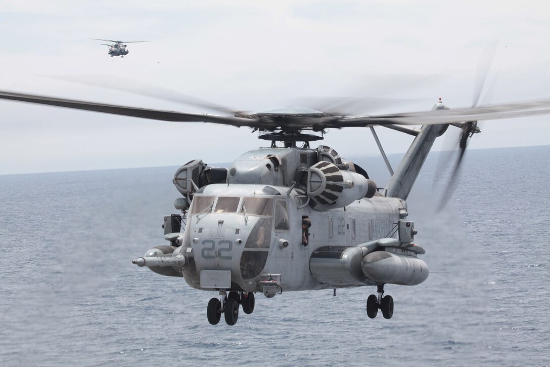 U.S. Marine Corps CH-53E Super Stallions with Marine Medium Tiltrotor Squadron 166 Reinforced (VMM- 166 (REIN)), 13th Marine Expeditionary Unit land aboard the USS Boxer (LHD-4) June 11, 2013 during PHIBRON-MEU Integration (PMINT). PMINT is a three week long pre-deployment training event focusing on the combined Marine Expeditionary Unit and Amphibious Ready Group capabilities and the strengthening of the Navy and Marine Corps team. (U.S. Marine Corps photo by Lance Cpl. David Gonzalez, 13th Marine Expeditionary Unit Combat Camera/ Released)