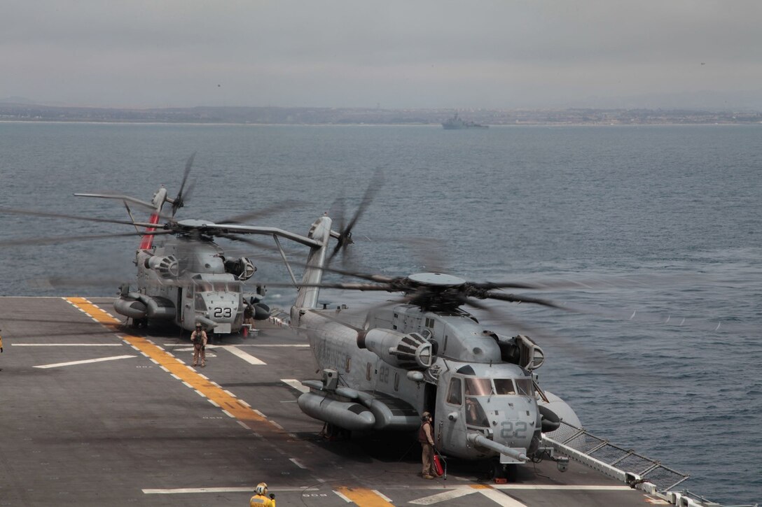 U.S. Marine Corps CH-53E Super Stallions with Marine Medium Tiltrotor Squadron 166 Reinforced (VMM- 166 (REIN)), 13th Marine Expeditionary Unit land aboard the USS Boxer (LHD-4) June 11, 2013 during PHIBRON-MEU Integration (PMINT). PMINT is a three week long pre-deployment training event focusing on the combined Marine Expeditionary Unit and Amphibious Ready Group capabilities and the strengthening of the Navy and Marine Corps team. (U.S. Marine Corps photo by Lance Cpl. David Gonzalez, 13th Marine Expeditionary Unit Combat Camera/ Released)