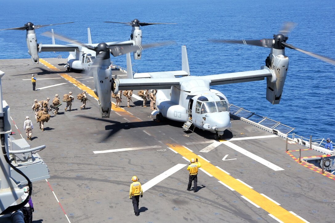 U.S. Marines with 1st Battalion, 4th Marine Regiment, 13th Marine Expeditionary Unit, board a MV-22B Osprey helicopter during Amphibious Squadron MEU Integration Training June 19, 2013. PMINT is a three week long pre-deployment training event focusing on the combined Marine Expeditionary Unit and Amphibious Ready Group capabilities and the strengthening of the Navy and Marine Corps team. (U.S. Marine Corps photo by Sgt. Jennifer J. Pirante, 13th Marine Expeditionary Unit Combat Correspondent/ Released)