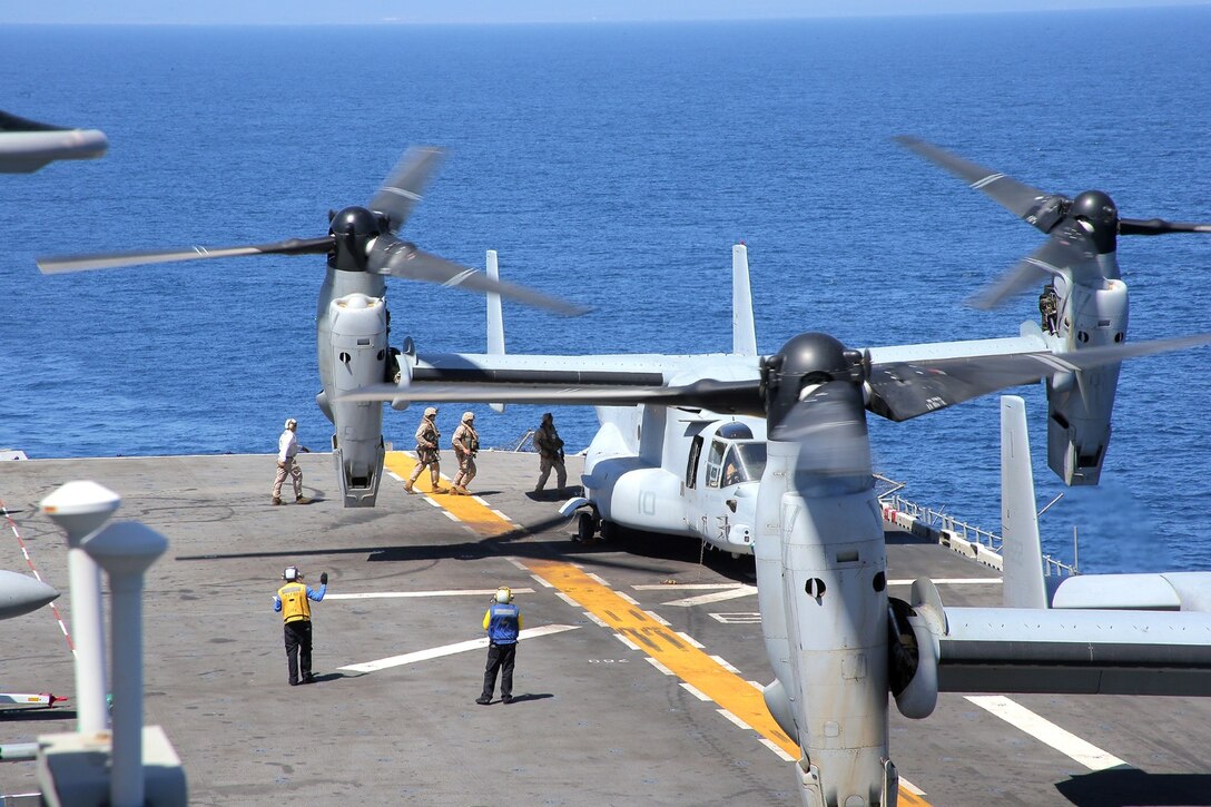 U.S. Marines with 1st Battalion, 4th Marine Regiment, 13th Marine Expeditionary Unit, board a MV-22B Osprey helicopter during Amphibious Squadron MEU Integration Training June 19, 2013. PMINT is a three week long pre-deployment training event focusing on the combined Marine Expeditionary Unit and Amphibious Ready Group capabilities and the strengthening of the Navy and Marine Corps team. (U.S. Marine Corps photo by Sgt. Jennifer J. Pirante, 13th Marine Expeditionary Unit Combat Correspondent/ Released)