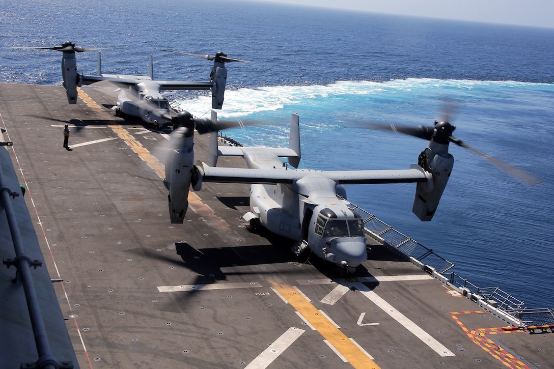 Two MV-22 Osprey helicopters with Marine Medium Tiltrotor Squadron 166 Reinforced (VMM- 166 (REIN)), 13th Marine Expeditionary Unit, are staged in a line aboard the USS Boxer as it turns during Amphibious Squadron MEU Integration Training June 19, 2013. PMINT is a three week long pre-deployment training event focusing on the combined Marine Expeditionary Unit and Amphibious Ready Group capabilities and the strengthening of the Navy and Marine Corps team. (U.S. Marine Corps photo by Sgt. Jennifer J. Pirante, 13th Marine Expeditionary Unit Combat Correspondent/ Released)