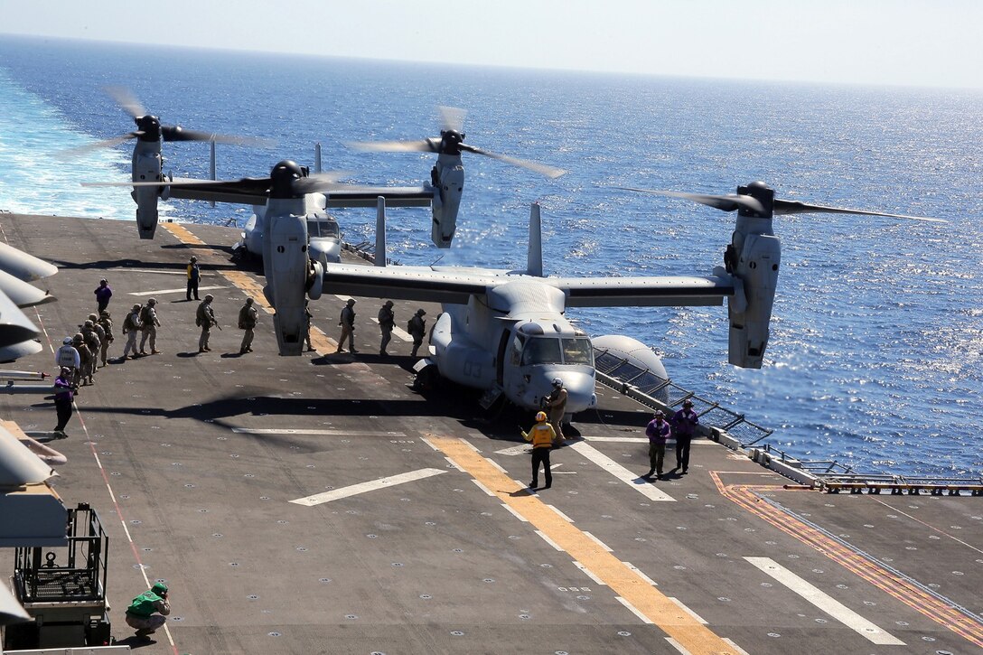 U.S. Marines with 1st Battalion, 4th Marine Regiment, 13th Marine Expeditionary Unit, board a MV-22B Osprey helicopter during Amphibious Squadron MEU Integration Training June 19, 2013. PMINT is a three week long pre-deployment training event focusing on the combined Marine Expeditionary Unit and Amphibious Ready Group capabilities and the strengthening of the Navy and Marine Corps team. (U.S. Marine Corps photo by Sgt. Jennifer J. Pirante, 13th Marine Expeditionary Unit Combat Correspondent/ Released)