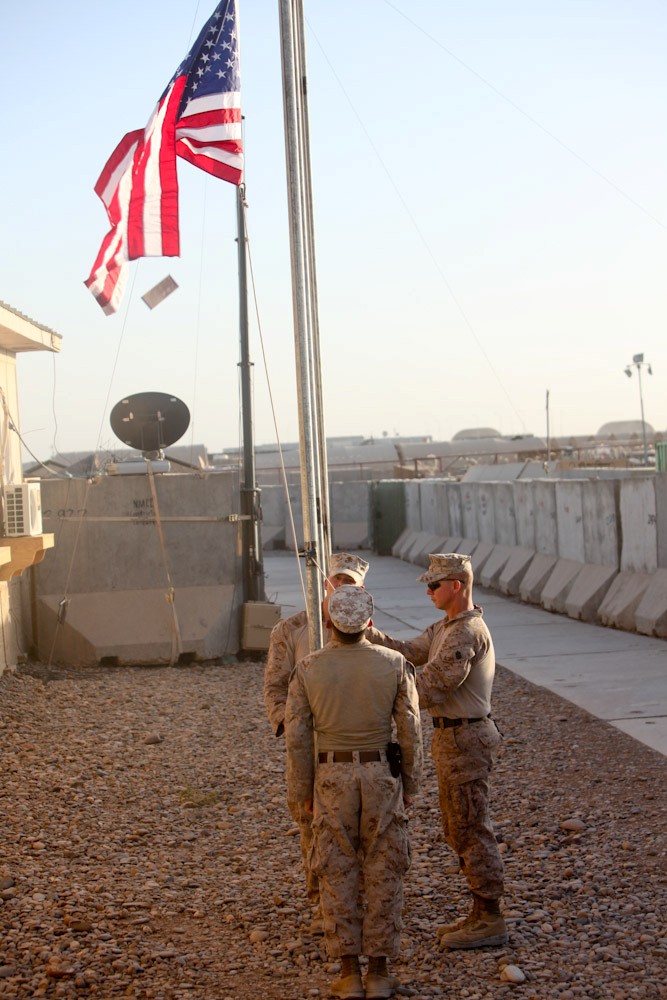 Camp Dwyer, Afghanistan - Sgt. Maj. Timothy Rudd, the battalion sergeant major of 2nd Battalion, 8th Marine Regiment, Regimental Combat Team 7, raises a flag for his father here, June 16, 2013. While several flags were raised for the fathers of the Marines and sailors of "America's Battalion," Rudd was the only Marine to individually raise a flag for his father. "For 23 years, I've been away from my father every Father's Day," said Rudd, a native of Post, Texas. "So this is something that I can give him, even if it's just symbolically."