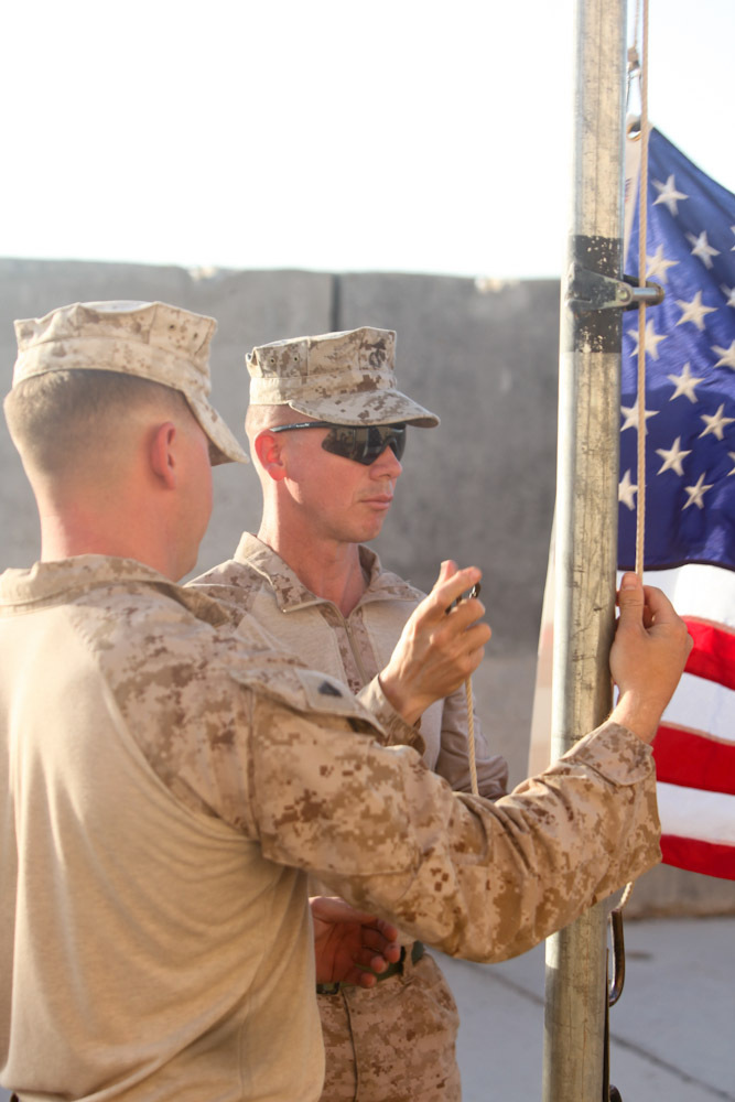 Sgt. Maj. Timothy Rudd, the battalion sergeant major of 2nd Battalion, 8th Marine Regiment, Regimental Combat Team 7, lowers the flag for his father here June 16, 2013. Rudd raised the flag to show his appreciation and love for his father. "Raising this flag was something I felt I owed to my father," said Rudd, a native of Post, Texas. "It was the least I could to do to show my gratitude for all that he's done for me over the years."