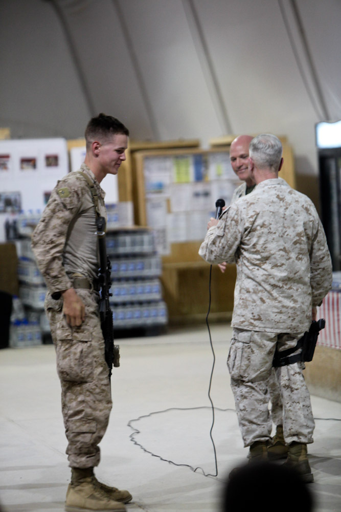 Pfc. Keith Crowley, 19, from St. Louis, an administrative clerk with Headquarters and Service Company, 2nd Battalion, 8th Marine Regiment, Regimental Combat Team 7, asks Commandant of the Marine Corps Gen. James Amos, and Sgt. Maj. of the Marine Corps Micheal Barrett a question here, June 19, 2013. "This was my first time meeting and speaking with the commandant," Crowley said. "I was a little nervous at first, but when he gave me his challenge coin all my nerves turned into excitement."