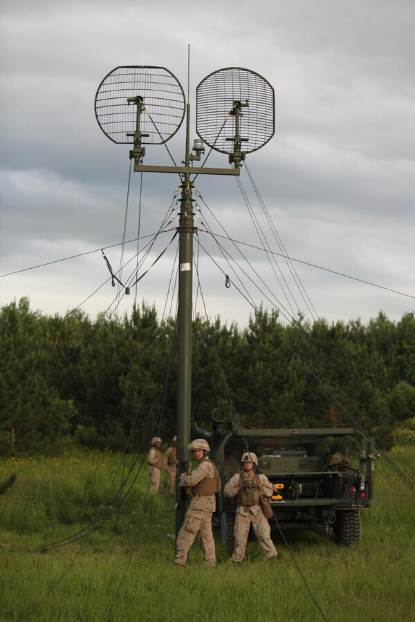 Marines with Headquarters Company, 25th Marine Regiment, stabilize an antenna at Exercise Heavy Metal 2013, here, June 17.  The antenna, a Tactical Elevated Antenna Mast System (TEAMS), allows groups of Marines located miles apart to share point-to-point phone service and internet communications.  These high-tech antennas are cared for and operated by Marines who practice the military occupational specialty of digital wide-band multi-channel equipment operators.  “Communication is key on the battlefield,” said Lt.Col. Charles Long, 6th Motor Transport Battalion inspector instructor and acting commander of the exercise. “This team allows units to move and communicate.  We’re able to disperse a satellite system across multiple sites using microwaves instead of running (long lengths) of cable.” 