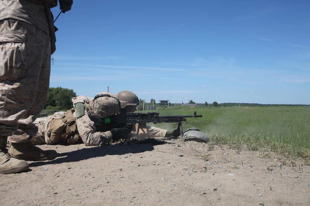 Marines with Company E, 2nd Battalion, 25th Marine Regiment, fire the M249 Squad Automatic Weapon on the range here as part of Exercise Heavy Metal 2013, June 20.  The team of Marines that carry the light machine gun includes the firing Marine, the target sighter/reloader, and a third man that brings ammunition when needed.  The Marines fired on targets up to 1,200 meters away exhibiting one of the capabilities of the Heavy Metal Task Force.  The exercise allowed the Marines to hone their skills as a unit for more than their monthly two-day drill periods. 
