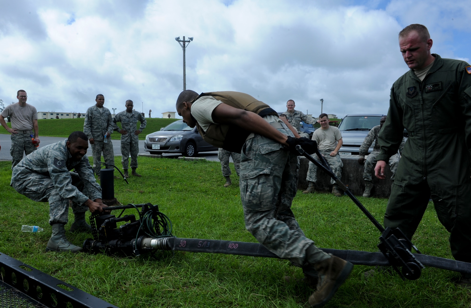 U.S. Air Force Senior Airman Jeremy Turner, 18th Logistics Readiness Squadron fuels distribution operator, pulls a squeegee to remove all the air from the hose during a forward area refueling point team try-out on Kadena Air Base, Japan, June 20, 2013. The try-out for the FARP team is composed of three portions; physical, written test and an interview. (U.S. Air Force photo by Airman 1st Class Justin Veazie/Released) 