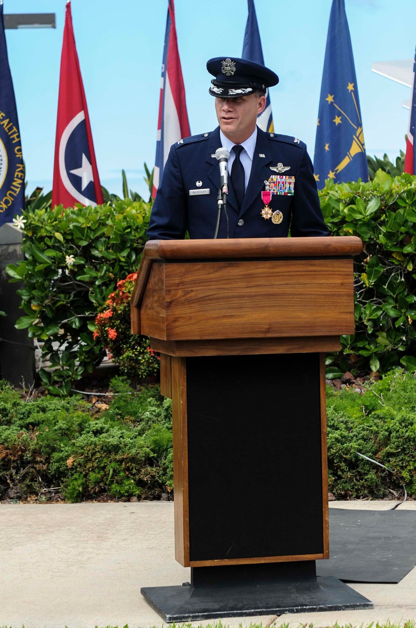 Col. Dan Baldessari, former 15th Operations Group commander, addresses the crowd before relinquishing command to incoming Commander, Col. Michael Merritt, during the change of command ceremony at the Missing Man Formation on Joint Base Pearl Harbor-Hickam, Hawaii, June 21, 2013. During his speech, Baldessari thanked the Airmen of the 15 OG for their hard work and dedication to the mission during his two year tenure as commander. (U.S. Air Force Photo/Staff Sgt. Terri Paden)