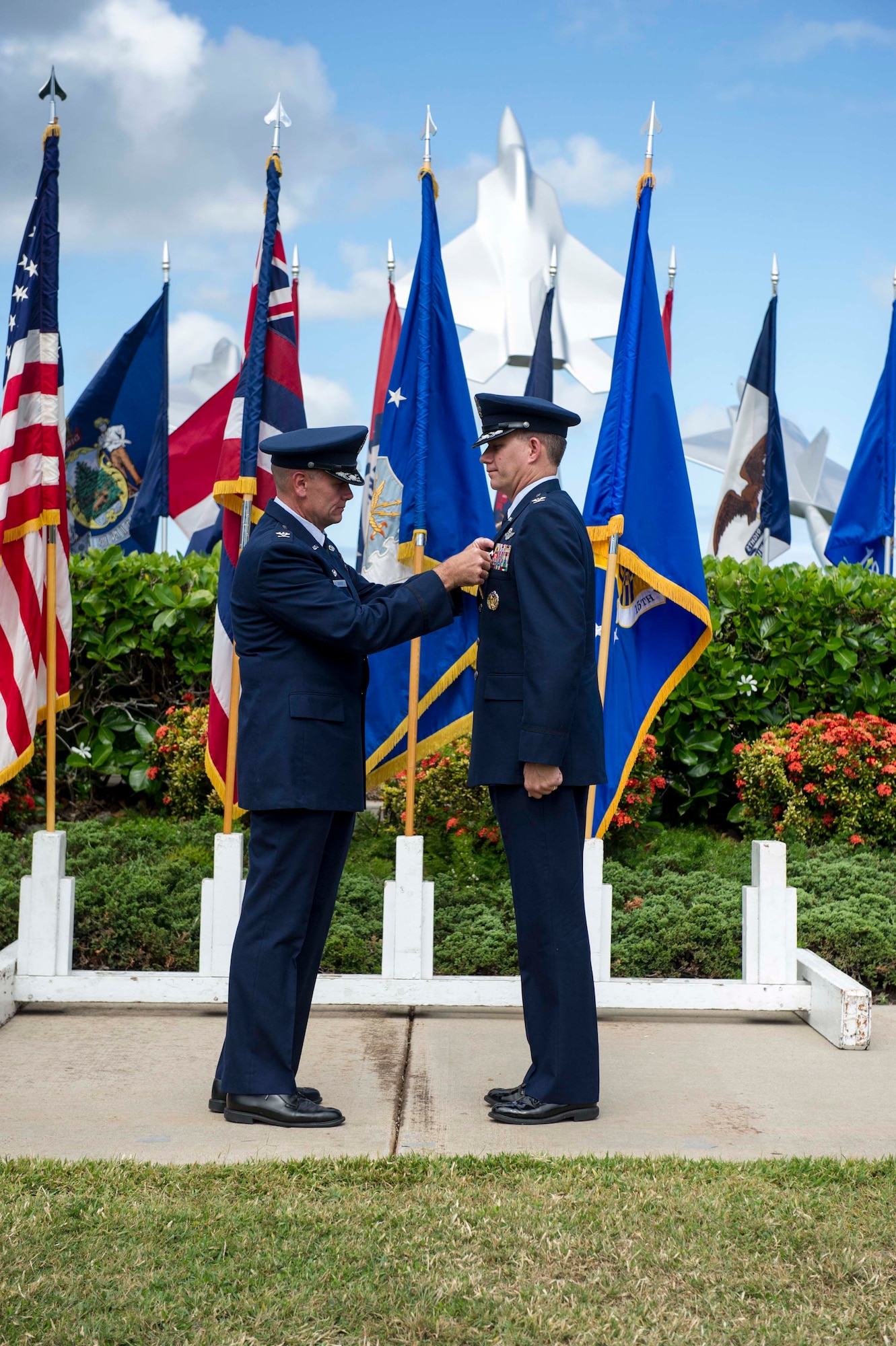 Col. Johnny Roscoe, 15th Wing commander, pins a Legion of Merit medal on Col. Dan Baldessari, former 15th Operations Group commander, prior to his change of command ceremony held at the Missing Man Formation on Joint Base Pearl Harbor-Hickam, Hawaii, June 21, 2013. The Legion of Merit is awarded for exceptionally meritorious conduct in the performance of outstanding services and achievements. The decoration is issued both to United States military personnel and to military and political figures of foreign governments. (U.S. Air Force Photo/Staff Sgt. Terri Paden)