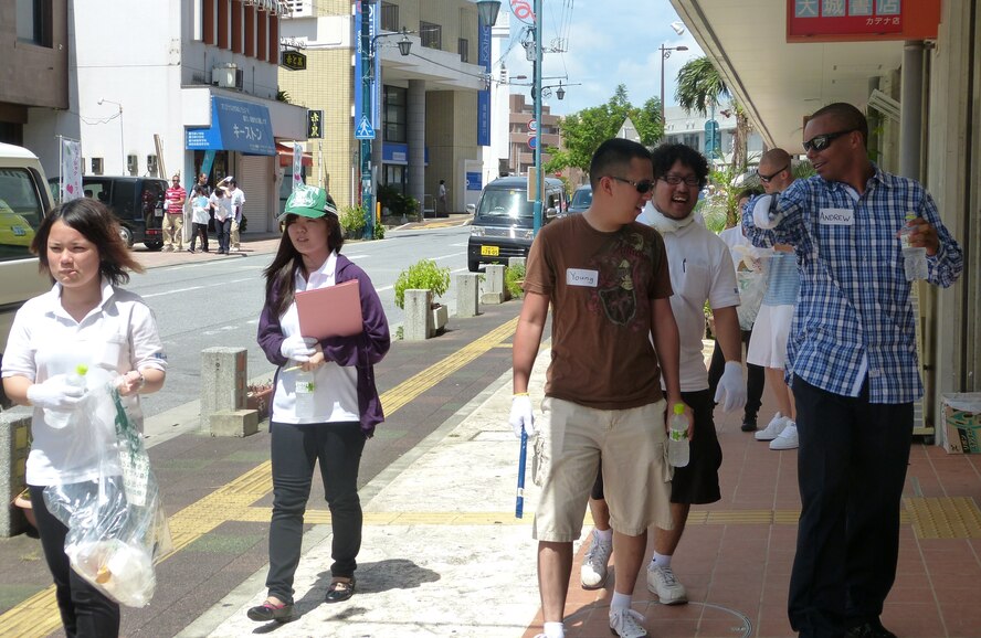 Kadena Language Institute students and 18th Wing volunteers talk about features of Kadena Town while walking and cleaning the neighborhood June 21, 2013. KLI is a two-year vocational school where students ages 19-24 learn different languages including English, and study Okinawan culture. (Courtesy photo) 