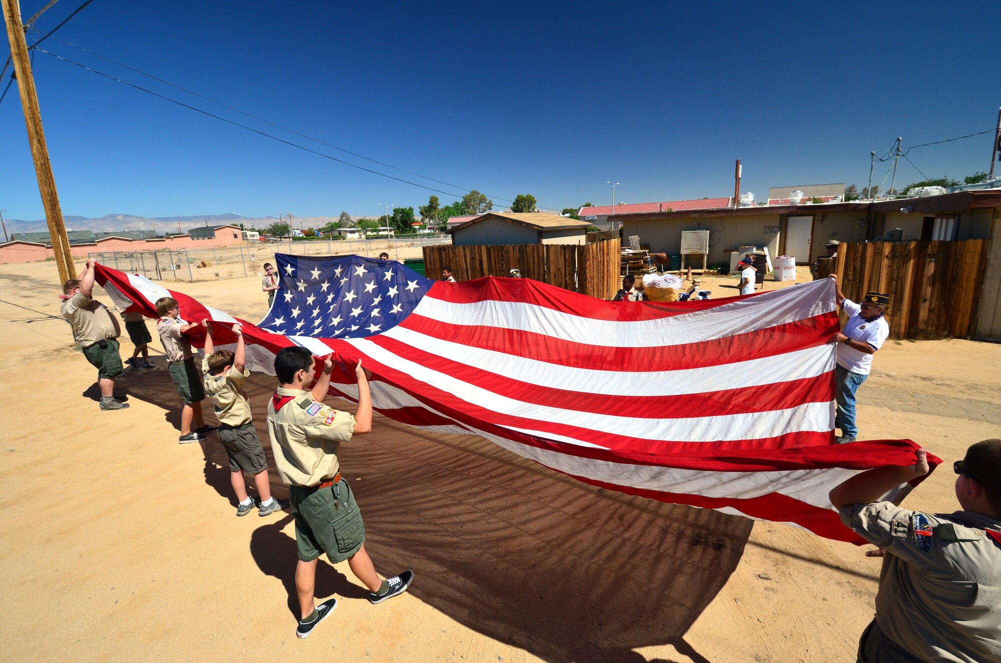 Boy Scout Troop 41 from Rosamond, Calif., prepare to ceremoniously burn a 30 foot by 50 foot American Flag that hung in one of the F-22 Integrated Test Force hangars. (Courtesy photo)