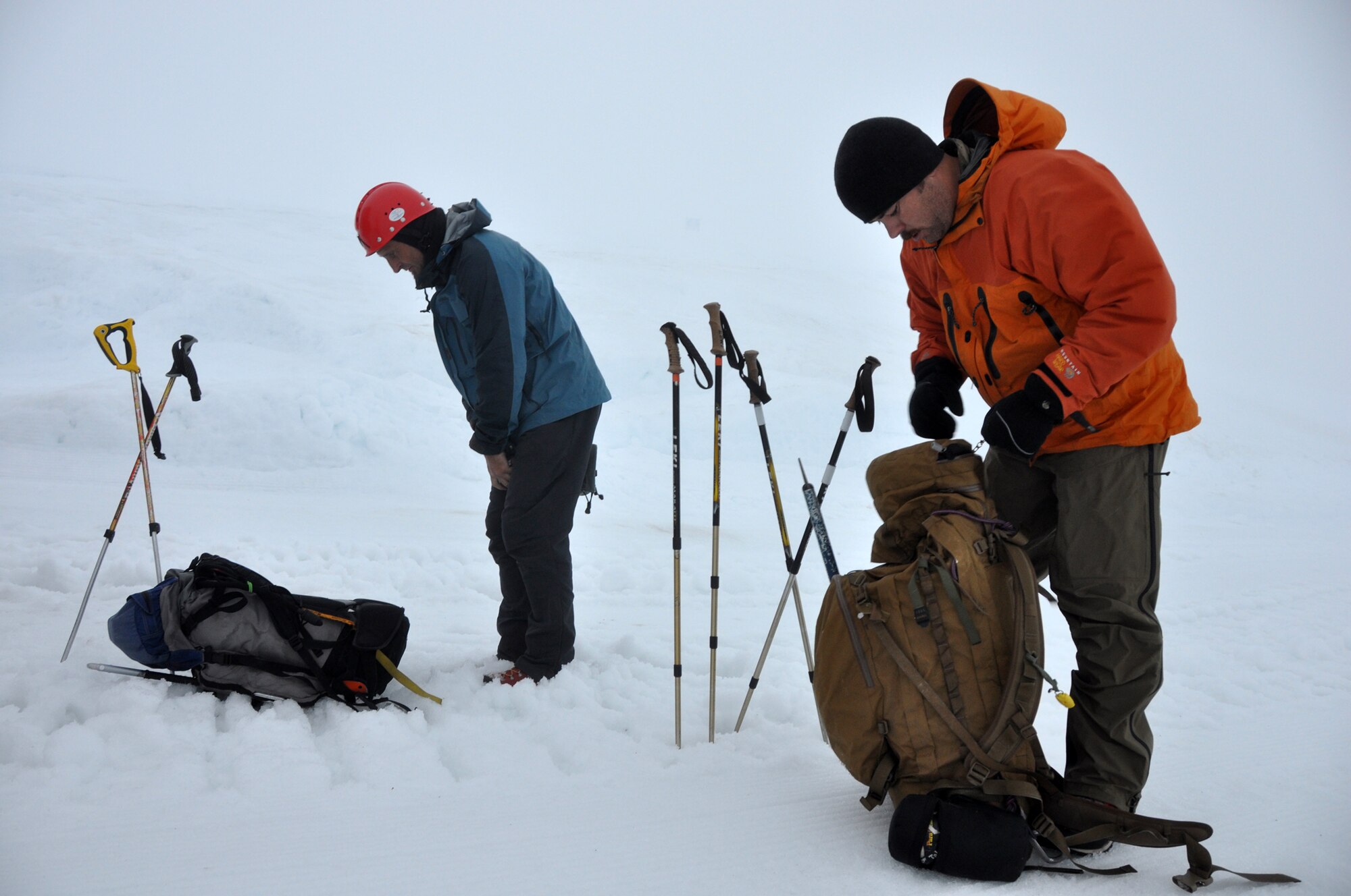 A 304th Rescue Squadron pararescueman and a civilian rescue searcher make final adjustments to their rescue equipment before searching for Kinley Adams, 59, who went missing Saturday on Mount Hood. Pararescuemen are the only members of the DoD specifically organized, trained and equipped to conduct personnel recovery operations in hostile or denied areas as a primary mission. (U.S. Air Force Photo/Staff Sgt. N. Daniel Delgado)