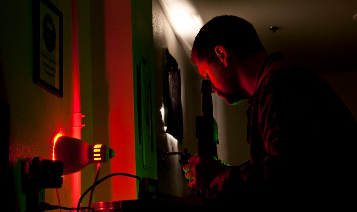 U.S. Air Force Staff Sgt. Kyle Burian, 58th Rescue Squadron aircrew flight equipment technician, looks into an ANV-126A night vision test machine June 24, 2013, at Nellis Air Force Base, Nev. Aircrew flight equipment Airmen test the 58th RQS night vision binoculars every 180 days to ensure optimal performance.  (U.S. Air Force photo by Senior Airman Daniel Hughes)