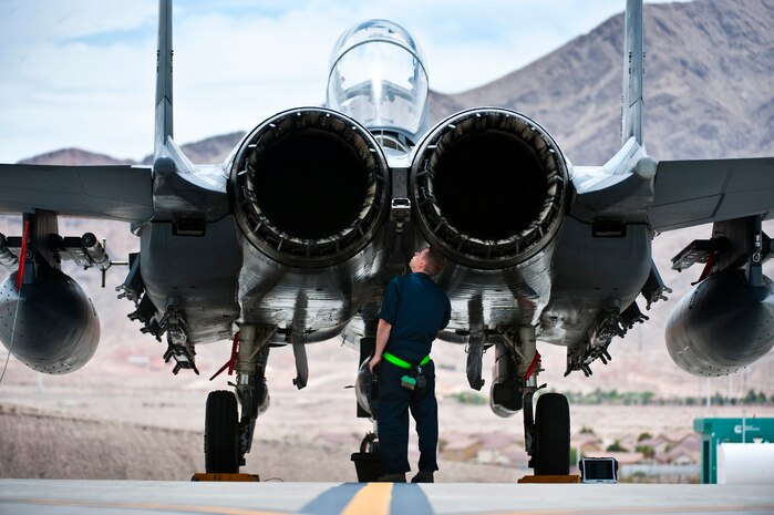 Senior Airman Nicholas Smyth, 4th Aircraft Maintenance Squadron crew chief, Seymour Johnson Air Force Base, N.C., inspects an F-15E Strike Eagle during Green Flag-West 13-5 June 24, 2013, at Nellis Air Force Base, Nev. A typical Green Flag exercise involves two multi-role fighter and/or bomber squadrons, unmanned aircraft, electronic warfare aircraft, and aerial refueling aircraft. (U.S. Air Force photo/Senior Airman Brett Clashman)