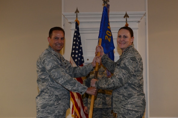 U.S. Air Force Col. Scott Arcuri, 20th Mission Support Group commander, passes the unit guide-on to Lt. Col. Tara White, the  incoming commander for the 20th Force Support Squadron at Shaw Air Force Base, S.C., June 17, 2013. Changes of commands are military tradition that represents the transfer of responsibilities from the presiding officials to the incoming official. (U.S. Air Force photo by Airman 1st Class Krystal M. Jeffers/Released)