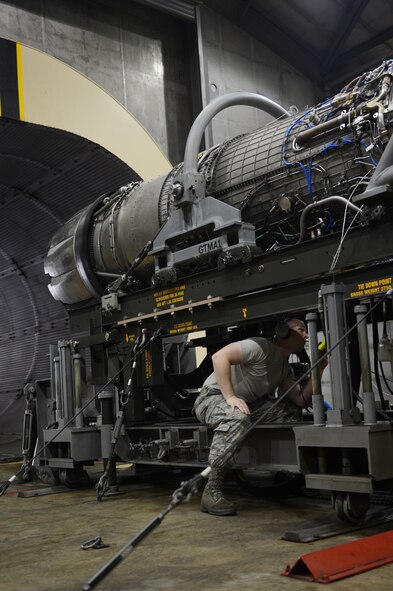 Senior Airman Kenneth Yelton, 20th Component Maintenance Squadron engine mechanic, examines an F-16 Fighting Falcon engine for leaks, loose bolts and malfunctions at the engine test facility of Shaw Air Force Base, S.C., June 13, 2013. The engine test facility, also called test cell, is one of the four sections of propulsion flight and every engine that is removed from a jet is tested there before being reinstalled. (U.S. Air Force photo by Airman 1st Class Krystal M. Jeffers/Released)