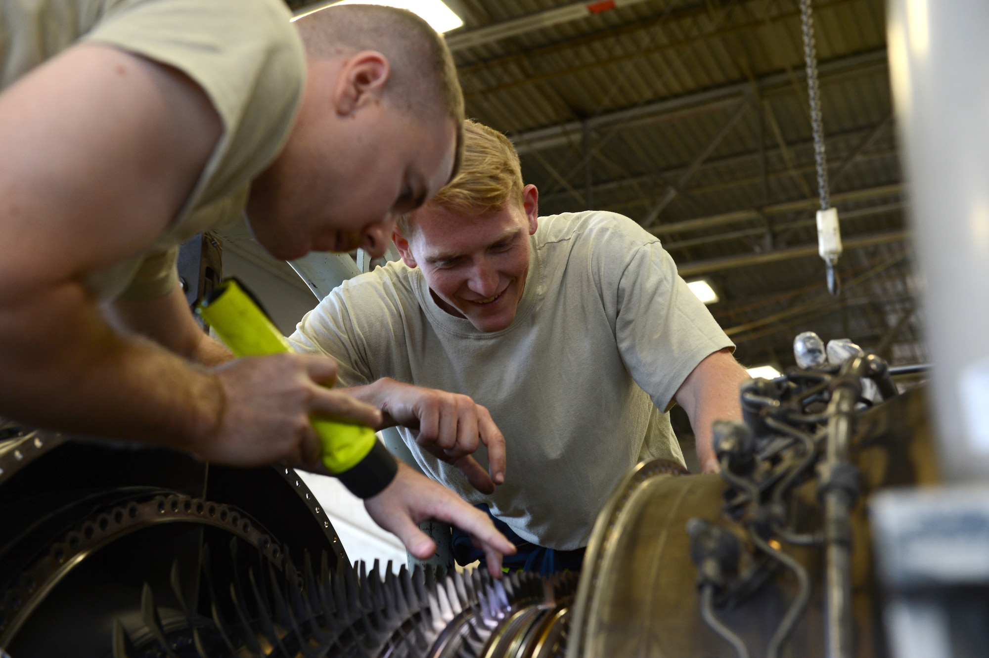 Senior Airman Dominic Mock and Airman 1st Class Christopher Wynn, 20th Component Maintenance Squadron aerospace propulsion technicians, inspect damage to the core blades of the F-16 Fighting Falcon’s engines at Shaw Air Force Base, May 15, 2013. The engines are called F110-general electric-129. (U.S. Air Force photo by Airman 1st Class Krystal M. Jeffers/Released)