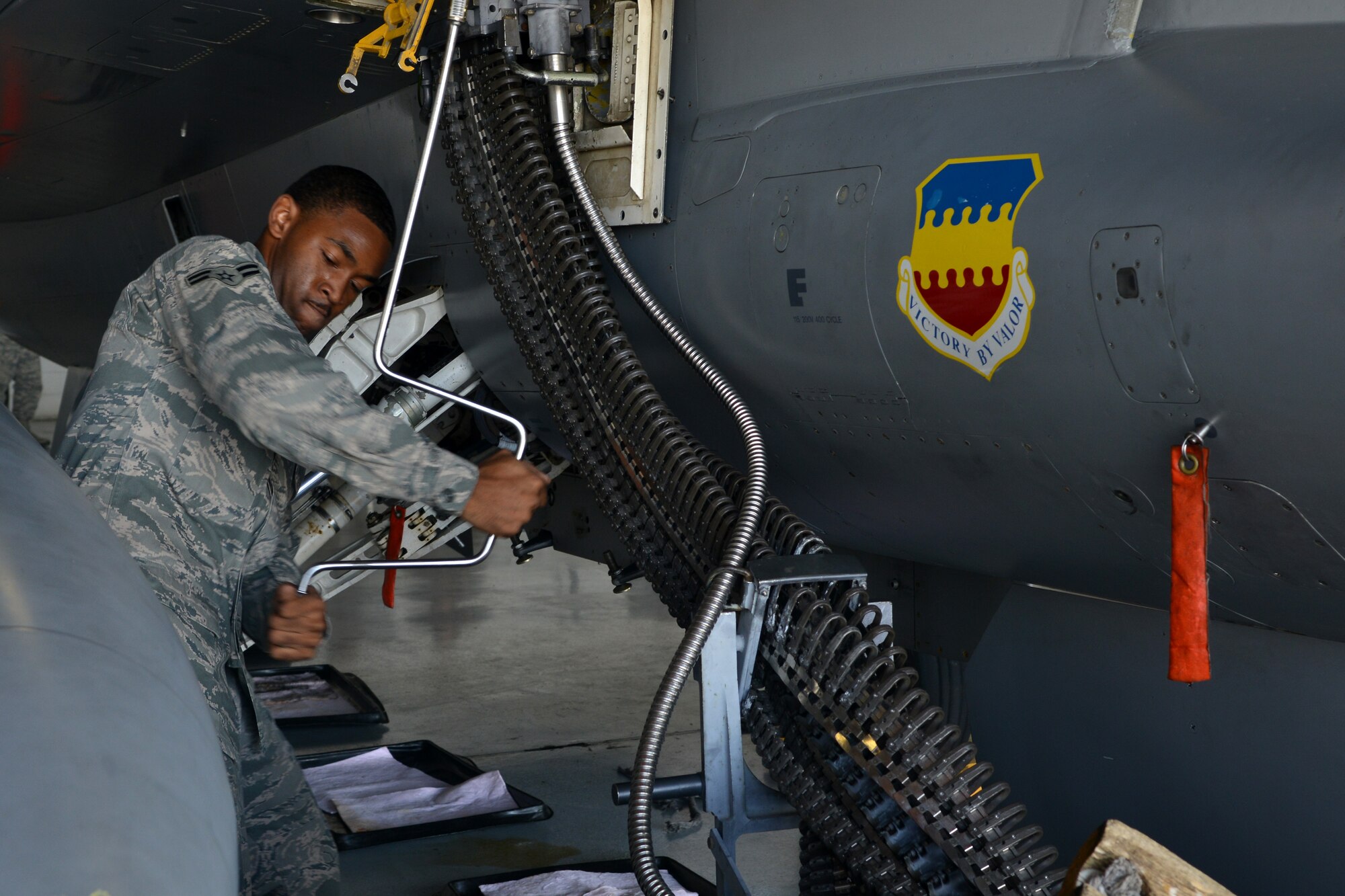 U.S. Air Force Airman 1st Class Grallian McBride, 20th Aircraft Maintenance Squadron weapons load crew member, loads ammunition onto an F-16 Fighting Falcon during a weapons load competition, Shaw Air Force Base, S.C., June 21, 2013. The competition consists of crew members from all three fighter squadrons. (U.S. Air Force photo by Airman 1st Class Ashley L. Gardner/Released)