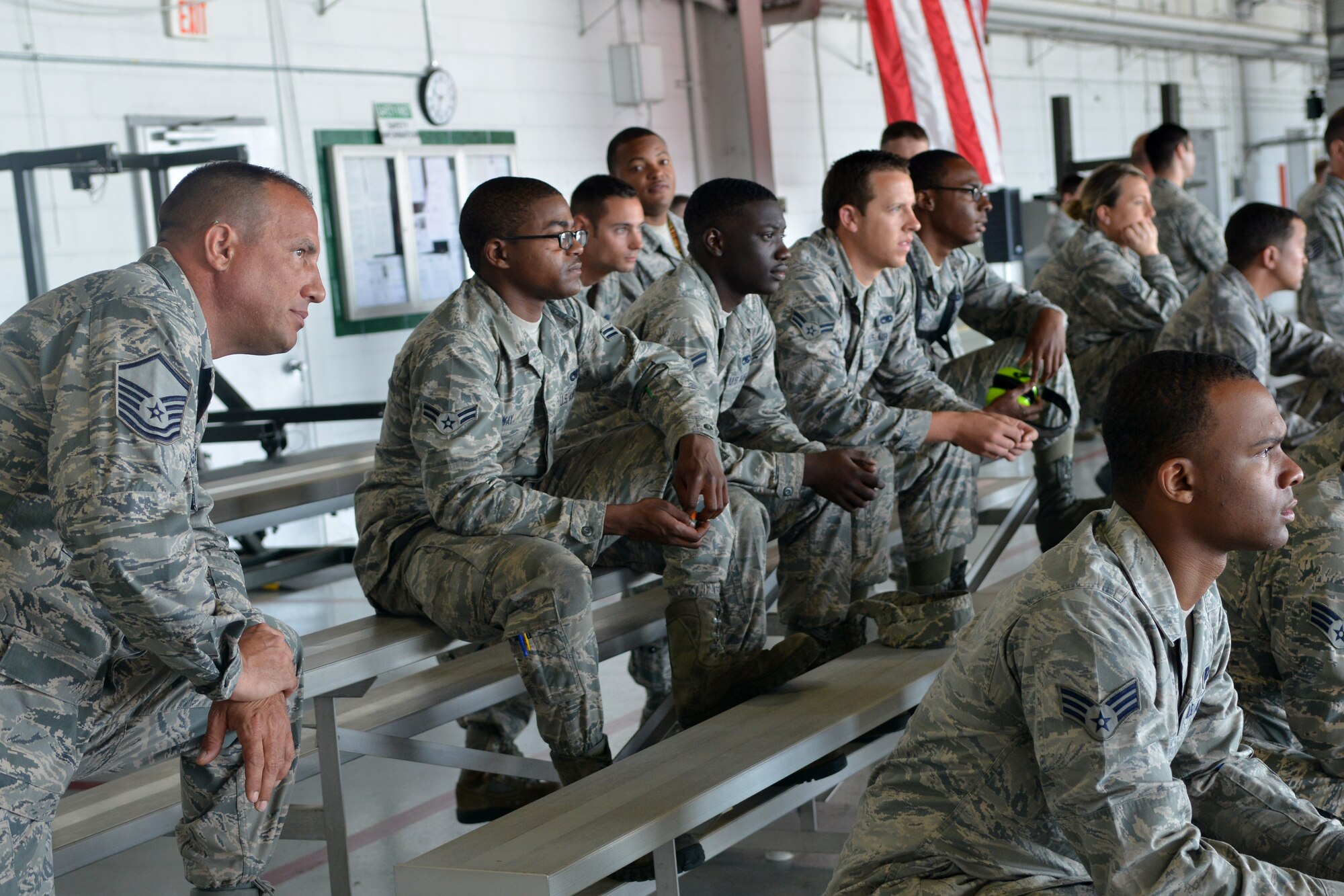 Airmen join together and watch intensely as the weapons load competition begins, Shaw Air Force Base, S.C., June 21, 2013. The competition consists of crew members from all three fighter squadrons. (U.S. Air Force photo by Airman 1st Class Ashley L. Gardner/Released)