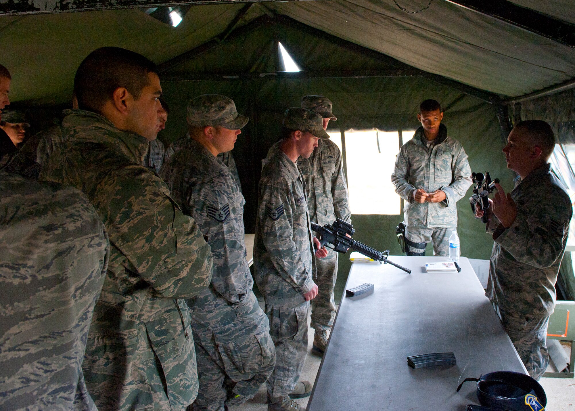 Staff Sgt. Austinlane Montgomery, 92nd Security Forces Squadron Combat Arms Training and Maintenance instructor, teaches members of Team Fairchild weapons familiarization for the M4 carbine assault rifle. Airman were preparing for an Ability to Survive and Operate training. (U.S. Air Force photo by Staff Sgt. Michael Means/Released)