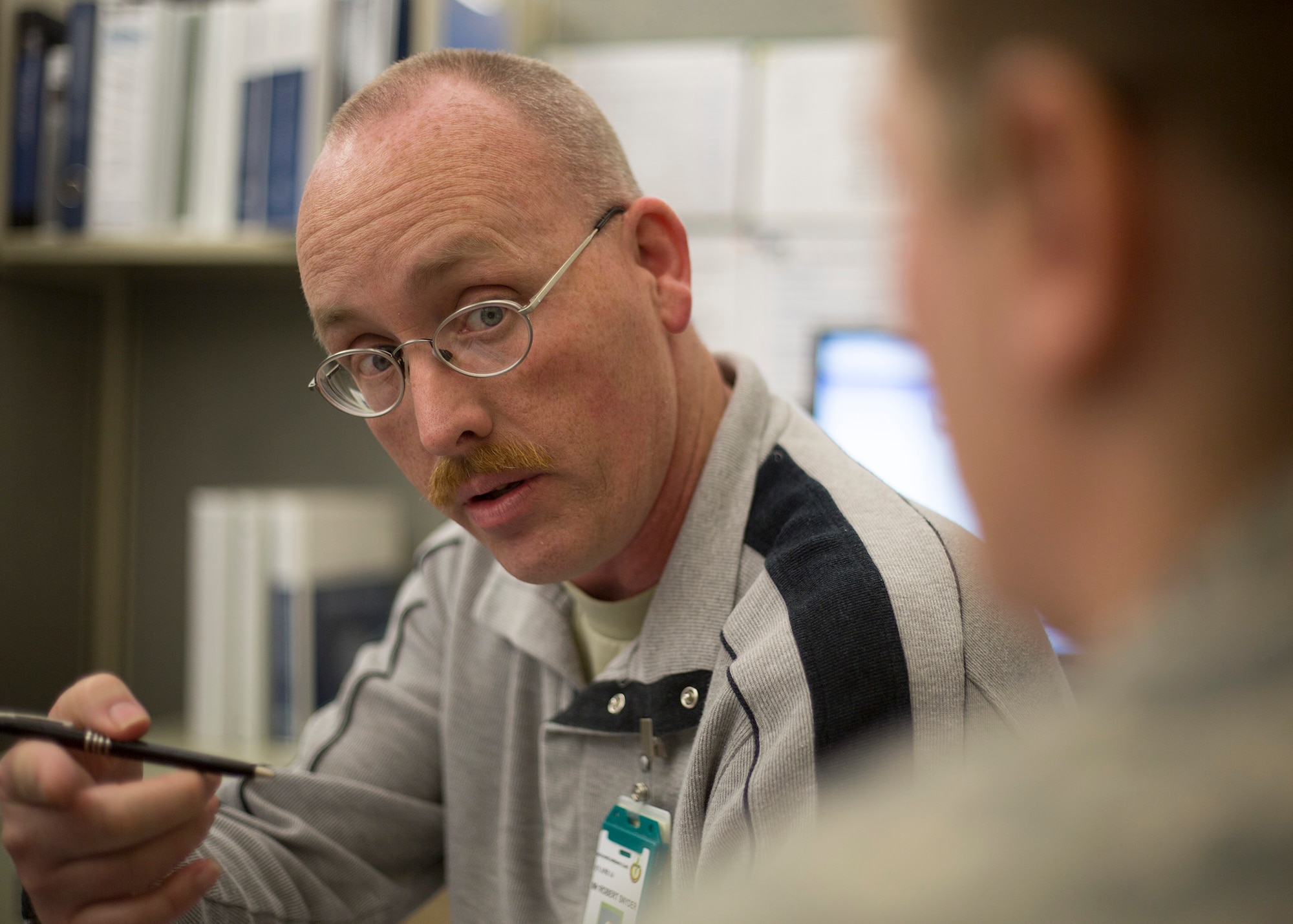 Robert Snyder, the Air Force Recovery Care Coordinator here at JBLM McChord Field, informs an Airman about the numerous ways he can aid her through the Integrated Disability Evaluation System, July 21, 2013. IDES transitions injured, ill, or wounded Airmen to veteran disability benefits, with ratings set between the Department of Defense and Veterans Affairs. Snyder is a resource and advocate, bound by client privacy, for active-duty Airmen, as well as Reservists and Air National Guardsmen who received their injuries while serving on Title 10 orders. Snyder is also a retired Air Force master sergeant who experienced IDES firsthand. (U.S. Air Force photo/Master Sgt. Jake Chappelle) 