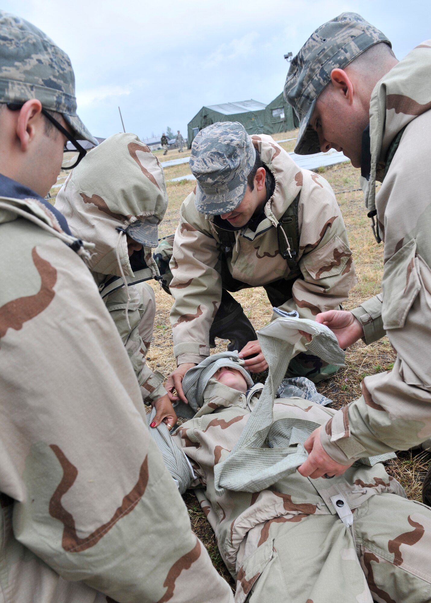 Members of Team Fairchild practice Self Aid and Buddy Care during Ability to Survive and Operate training at Fairchild Air Force Base, Wash., June 20, 2013. Airmen learned basic first aid, advanced life saving skills and battlefield tools such as the touniquet, bandages and other tools that are critical in saving lives down range. (U.S. Air Force photo by Staff Sgt. Michael Means/Released)