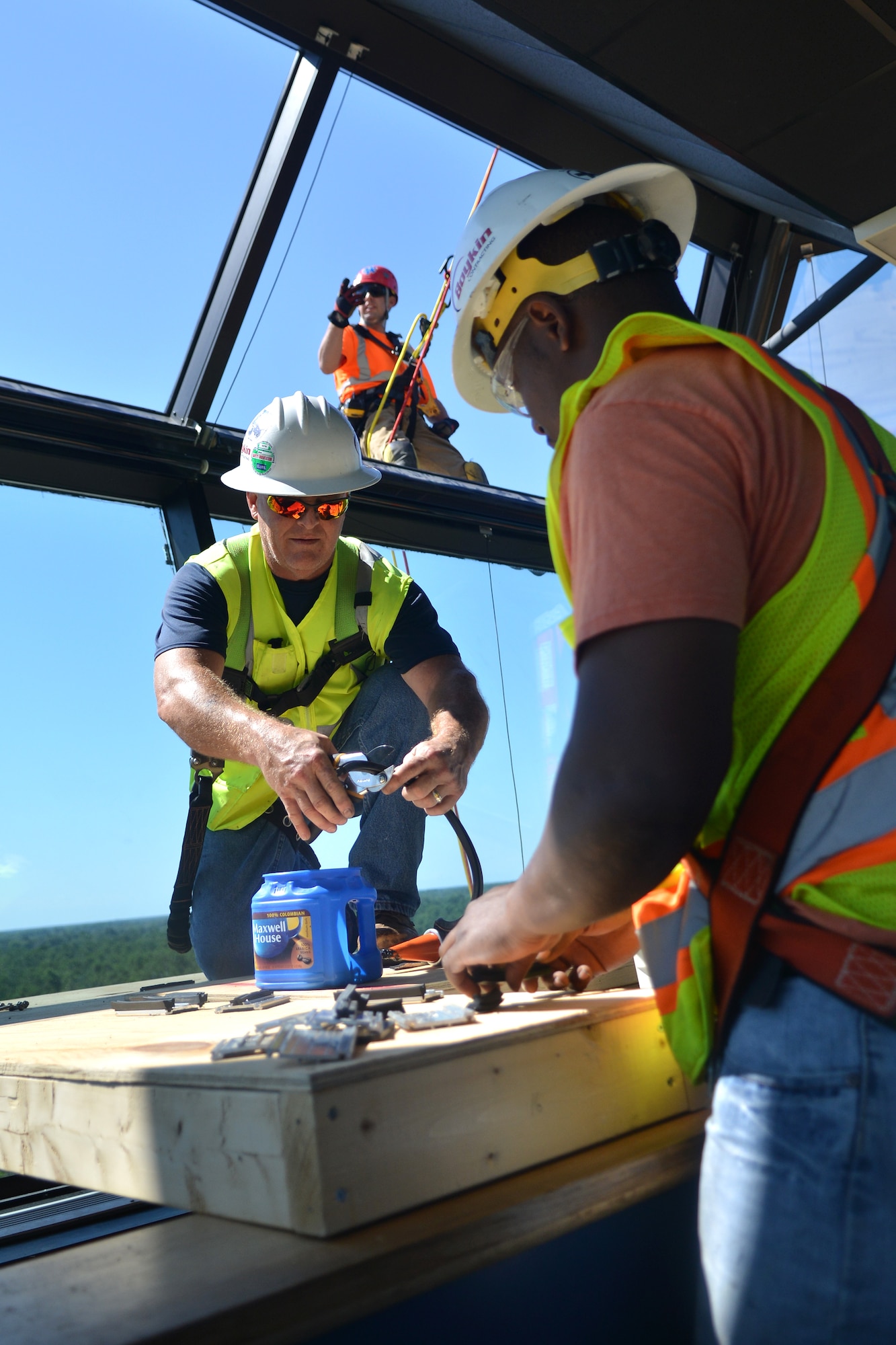 Boykin contractors look through the tools needed to help them finish the process of setting the windows in place, Shaw Air Force Base, S.C., June 21, 2013. The air tower has been undergoing maintenance since September, which recently has led into a replacement of all the windows. (U.S. Air Force photo by Airman 1st Class Ashley L. Gardner/Released)