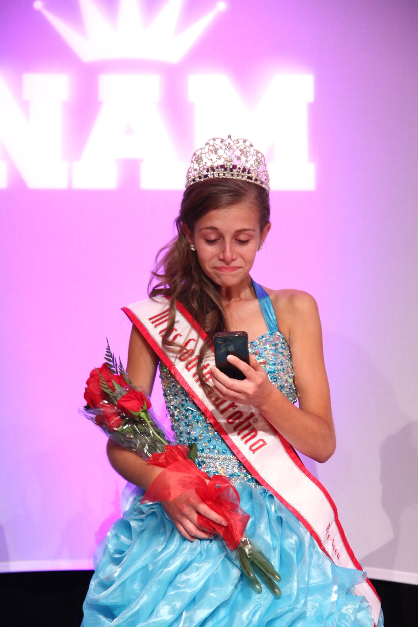 Alexandra Tiek, daughter of Chief Master Sgt. Jason Tiek, 20th Aircraft Maintenance Squadron, Tiger Aircraft Maintenance Unit superintendent and Senior Master Sgt. Lenora Tiek 20th Communications Squadron, speaks to her deployed mother on face time after earning the prestigious title Miss South Carolina Pre-teen in the 2013 South Carolina National American Miss Pageant at Columbia, S.C., June 14 and 15. Lenora is currently deployed with the 455th Expeditionary Communications Squadron as the unit’s chief enlisted manager at Bagram Airfield, Afghanistan. (Courtesy photo)