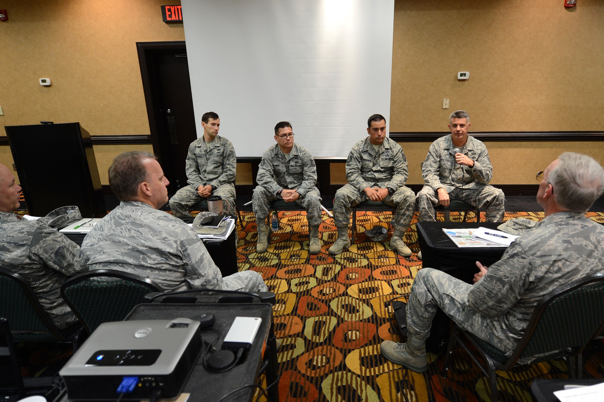 U.S. Air Force Airmen from the 20th Civil Engineer Squadron explosive ordnance disposal at Shaw Air Force Base speak at a chaplain symposium at the Holiday Inn, Columbia, S.C., June 18, 2013.  The EOD Airmen spoke about combat deployments and the vital role that chaplains had played for them.  (U.S. Air Force photo by Airman Nicole Sikorski/Released)