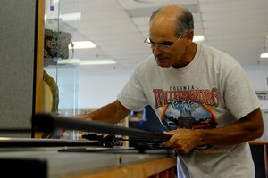 Ernie Sanchez, framing and matting instructor, creates mats in preparation for his class at Langley Air Force Base, Va., June 20, 2013.  The Arts and Crafts Center provides the opportunity to learn a craft, as well as provides custom frames for any occasion. (U.S. Air Force photo by Senior Airman Kayla Newman/Released)