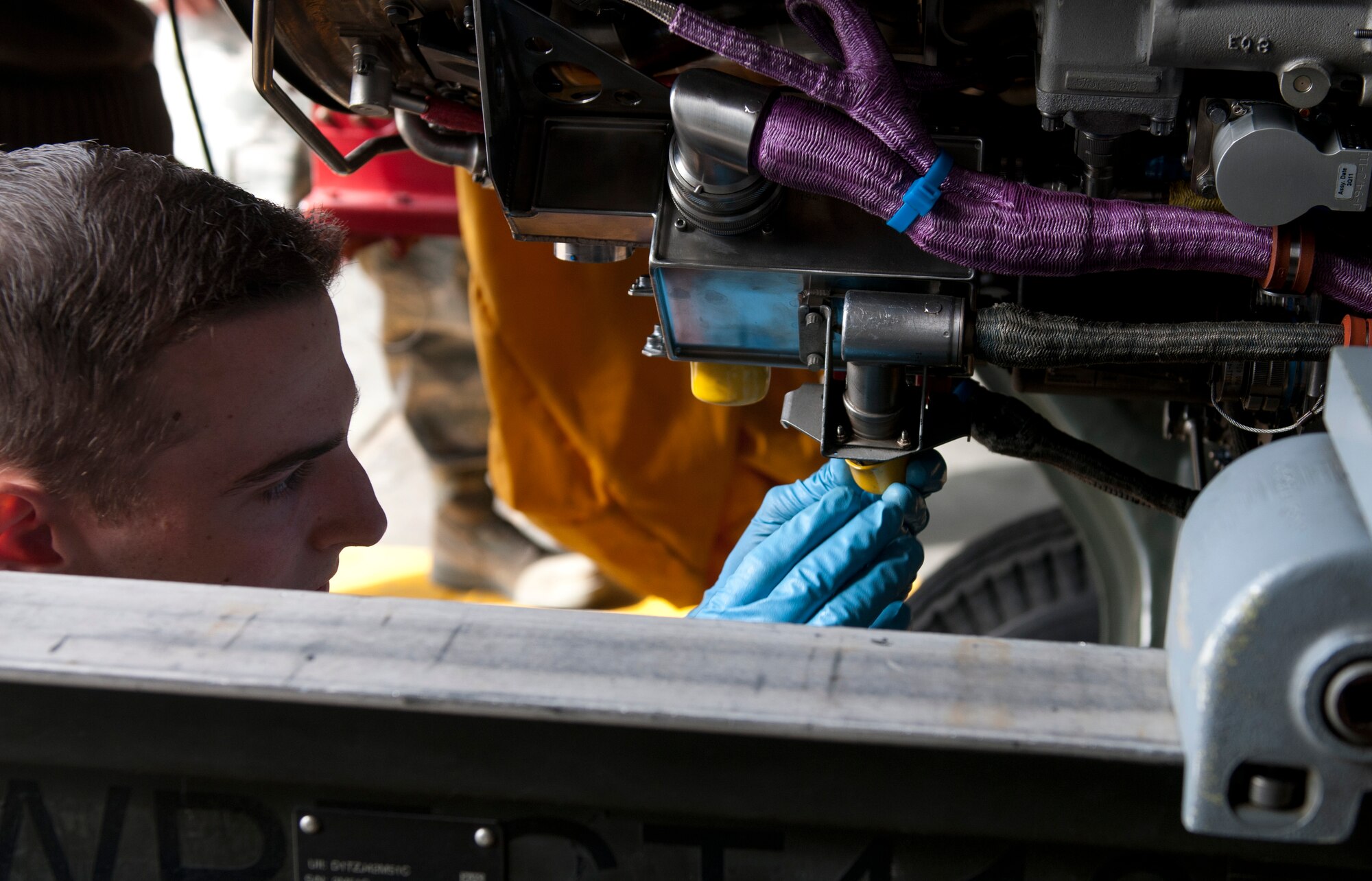 U.S. Air Force Airman 1st Class Steven Pritchard, 366th Component Maintenance Squadron aerospace propulsion apprentice, places a rubber cap over a part of an engine after the completion of  a test run, May 5, 2013, at Mountain Home Air Force Base, Idaho. Once the engine passes the run and several others checks are complete, the engine becomes a spare. (U.S. Air Force photo by Senior Airman Heather Hayward/Released)