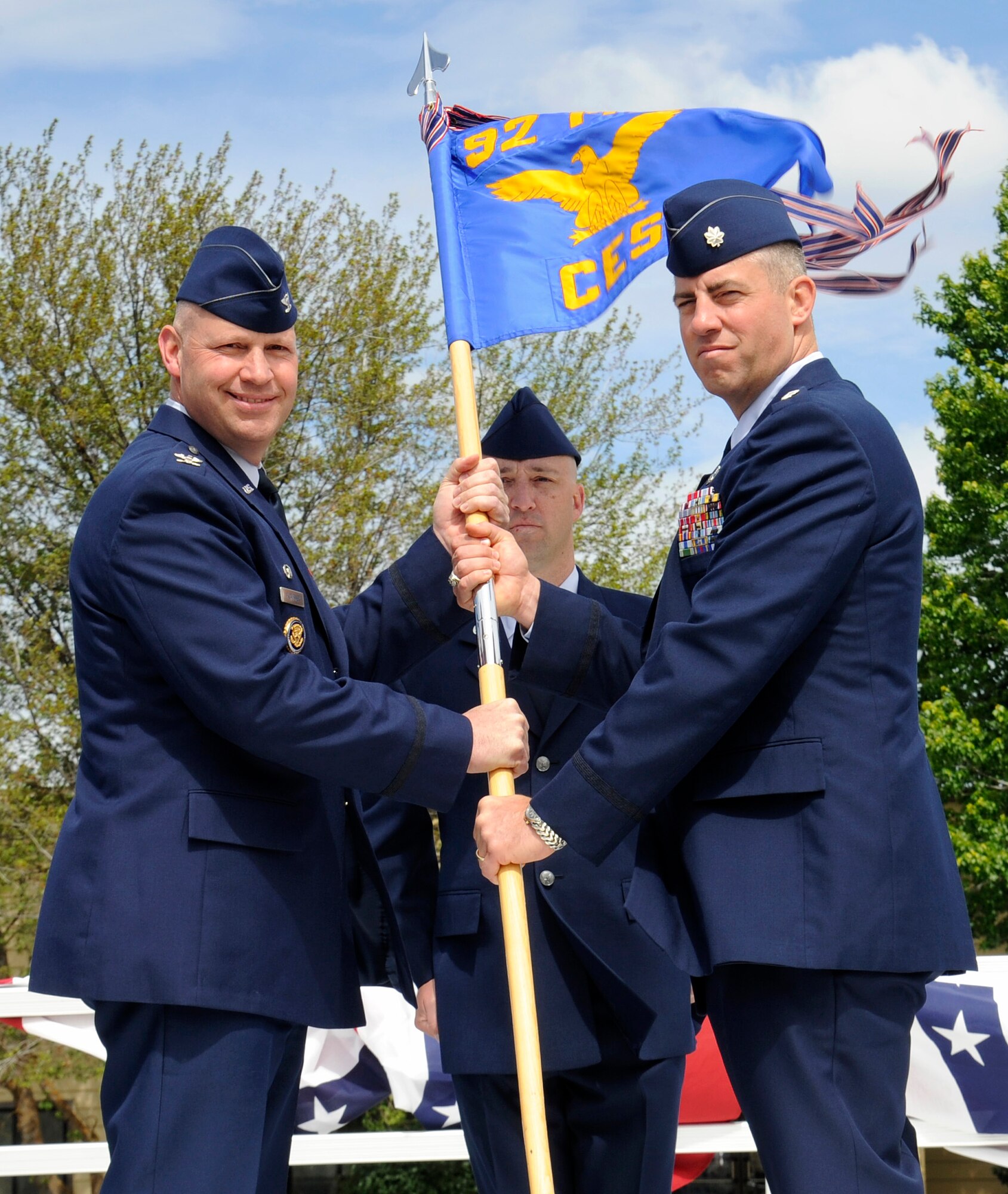 Col. Konrad Klausner, 92nd Mission Support Group commander, hands off the guidon to Lt. Col. Jason Campbell, 92nd Civil Engineer Squadron commander, during the 92nd CES change of command ceremony at Fairchild Air Force Base, Wash., June 14, 2013. The change of command ceremony is a tradition that represents a formal transfer of authority and responsibility. (U.S. Air Force photo by Airman 1st Class Ryan Zeski)
