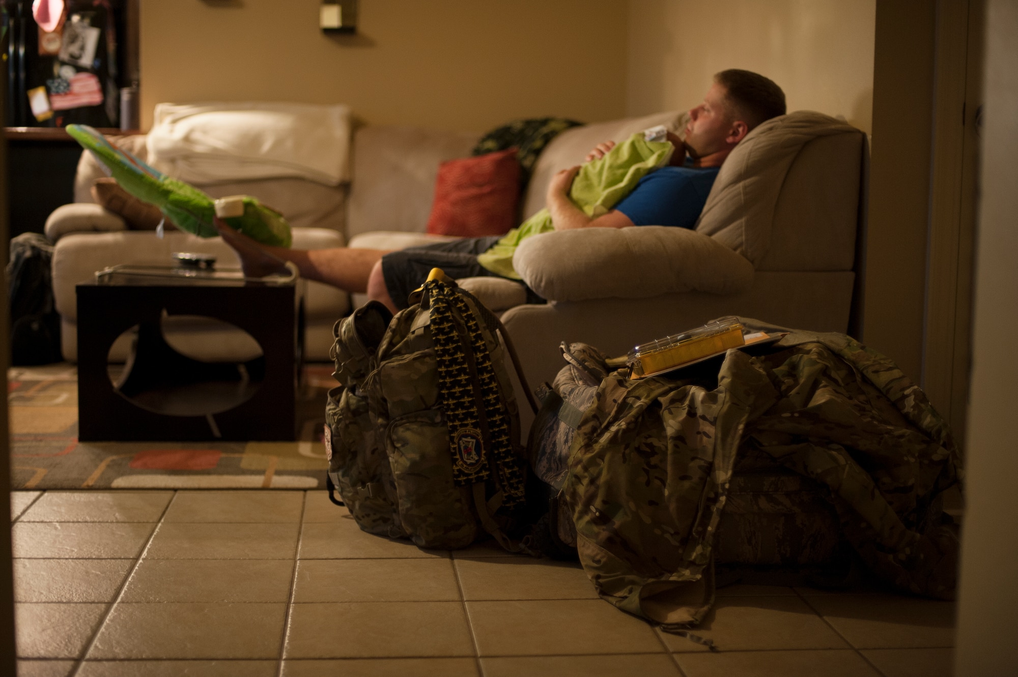 Tech. Sgt. Aaron Drain holds his son, Everett, before bedtime Aug. 29, 2012, in Cabot, Ark. Drain’s bags were already packed, and he would leave for Afghanistan in less than a week. (U.S. Air Force photo by Staff Sgt. Russ Scalf)