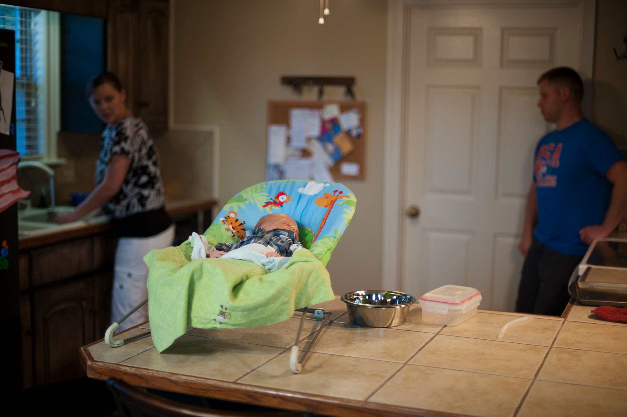Tech. Sgt. Aaron Drain and his wife, Heather, discuss his upcoming deployment Aug. 29, 2012, at their home in Cabot, Ark. Heather had just given birth to the couple’s second child three weeks prior and was working through a range of emotions.  (U.S. Air Force photo by Staff Sgt. Russ Scalf)
