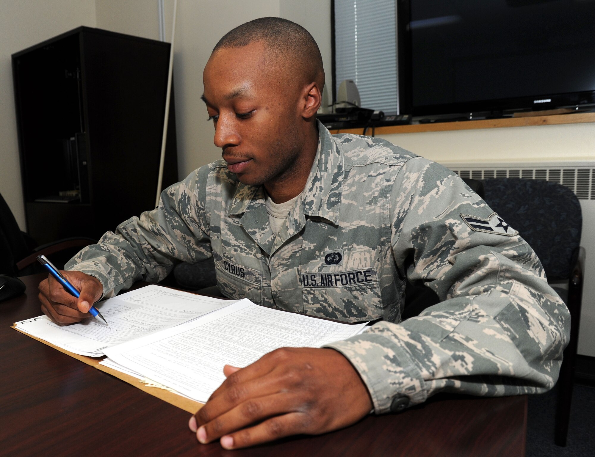 Airman 1st Class Jahrod Cyrus, 92nd Comptroller Squadron travel pay technician, reviews manual vouchers for accessions into the Air Force at Fairchild Air Force Base, Wash., June 20, 2013. Cyrus has been selected as Fairchild’s Finest. (U.S. Air Force photo by Airman 1st Class Janelle Patiño/Released)