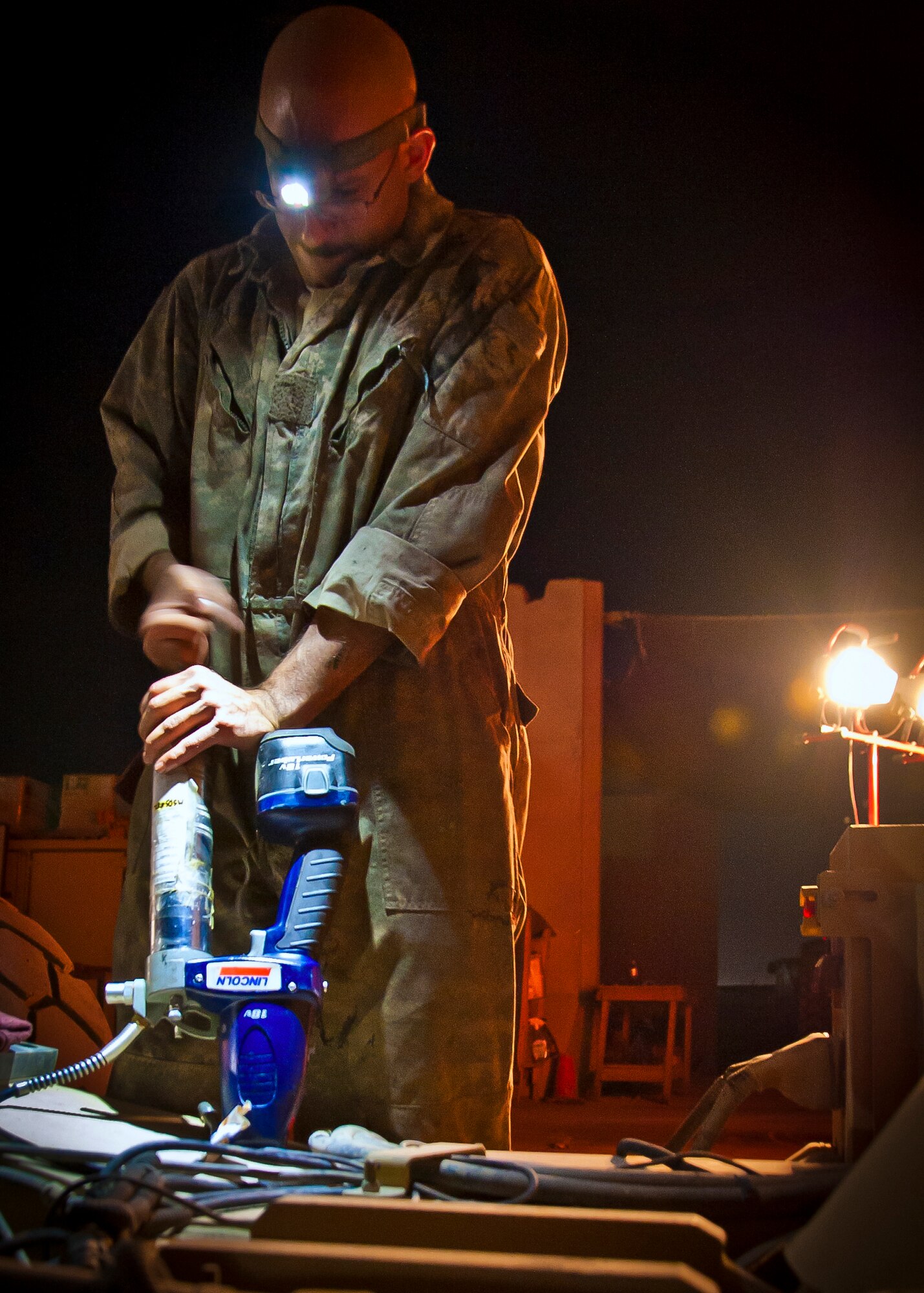 U.S. Air Force Tech. Sgt. Matthew Manfredi, 451st Expeditionary Logistics Readiness Squadron and is deployed here from the 100th Logistics Readiness Squadron at Royal Air Force Mildenhall, United Kingdom, work on a Halvorsen 25K aircraft cargo loader at Kandahar Airfield, Afghanistan, May 29, 2013. The cargo loader is a rapidly deployable, high-reach mechanized aircraft loader that can transport and lift up to 25,000 pounds of cargo and used by the ELRS to load military and civilian aircraft. (U.S. Air Force photo/Senior Airman Scott Saldukas)