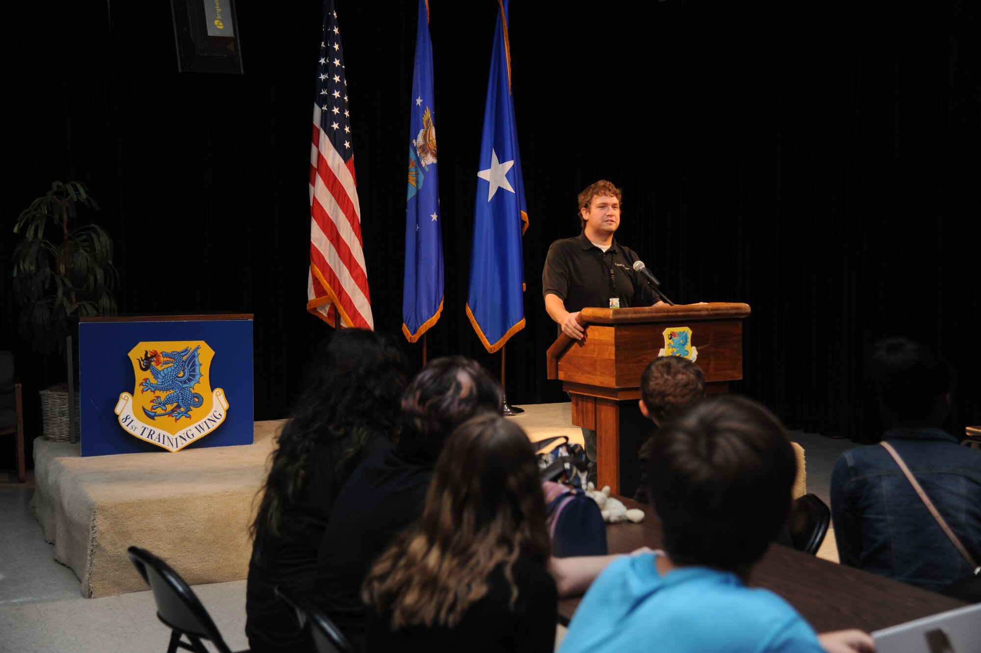 Matt Hames, K-Mar Industries contract videographer, introduces himself during a mock press conference to children from the youth center June 21, 2013, at Wall Studio, Keesler Air Force Base, Miss.  The youth center teen summer camp program also toured the public affairs office and other visual information services such as photo, video, graphics..  (U.S. Air Force photo by Kemberly Groue)